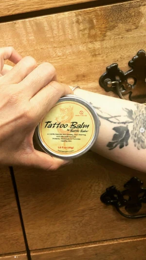 Battle Balm Tattoo balm user who rubs Battle Balm Tattoo balm on skin to make skin art pop and keep skin healthy and vibrant.