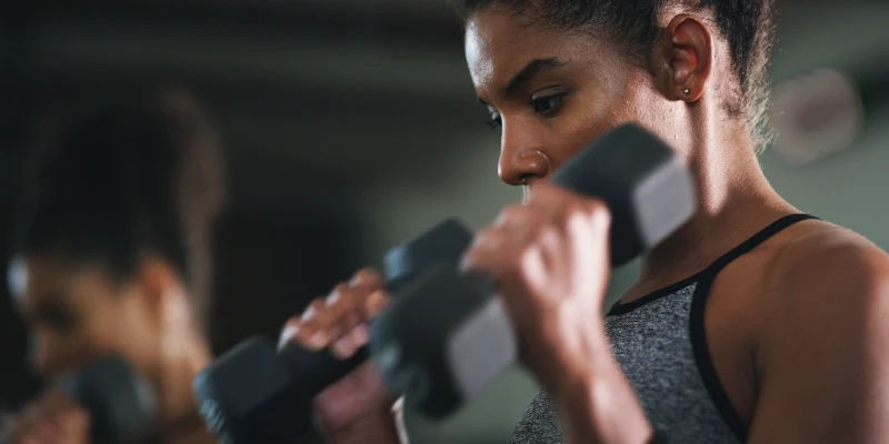 Female athlete lifting weights with no pain